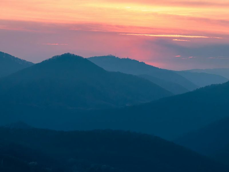 A serene landscape at sunset with soft colors.